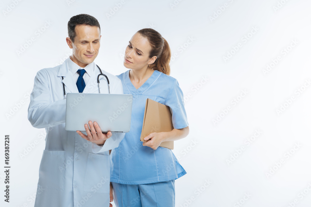 Interested medical workers looking at laptop Interested medical workers looking at laptop
