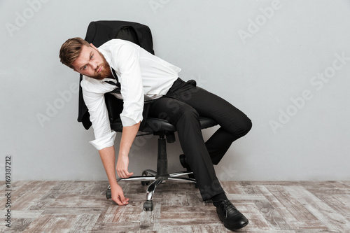 Tired drunk businessman resting in office chair