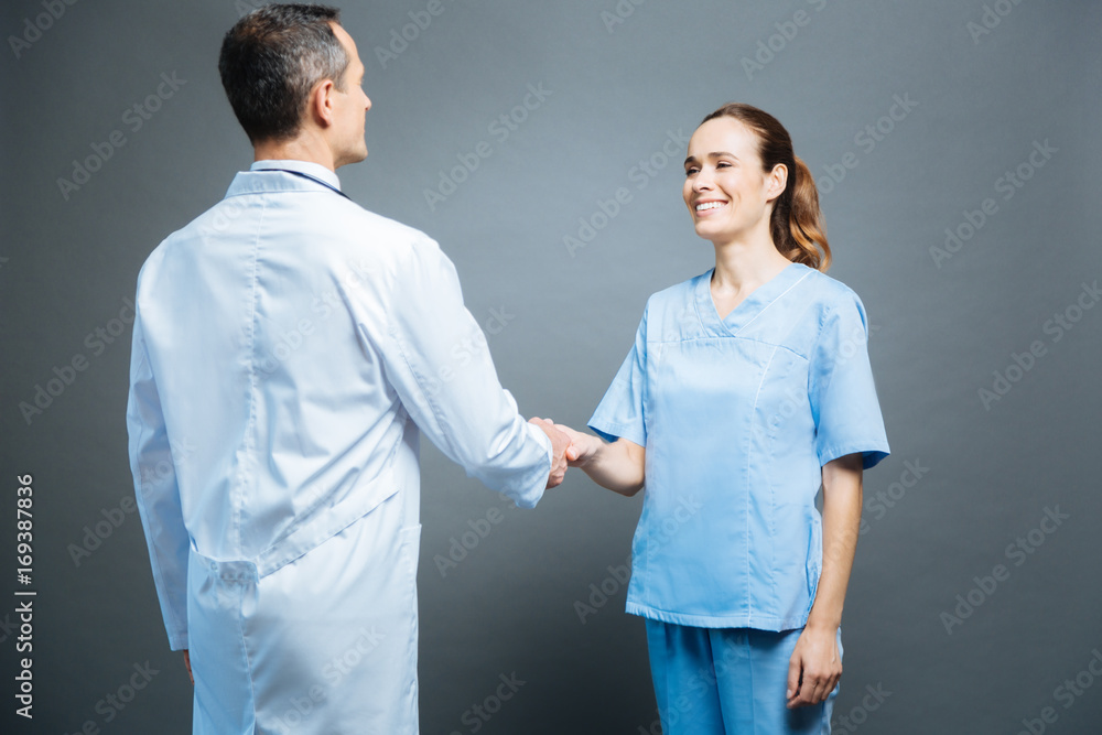 Friendly medical professionals shaking hands Friendly medical professionals shaking hands