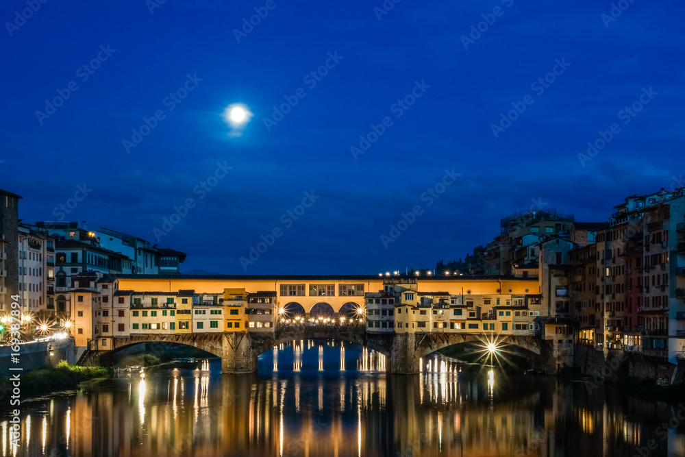 Ponte Vecchio over Arno river at night in Florence, Italy.