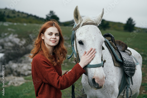 Beautiful woman is walking with a horse