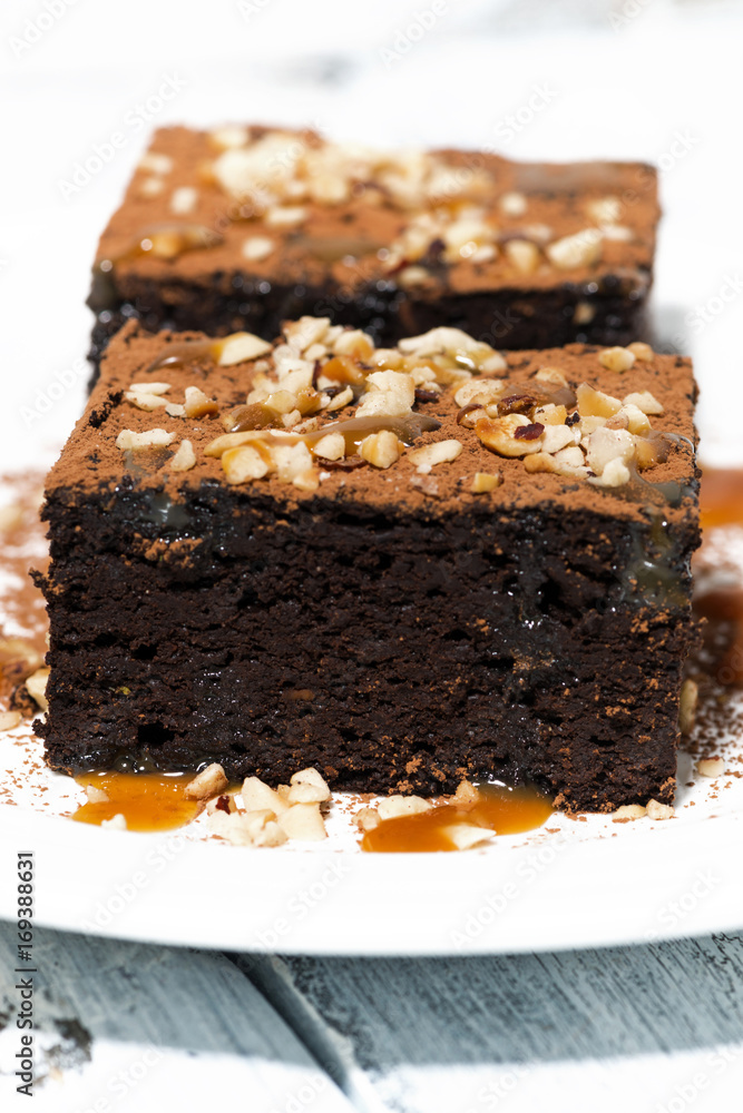 dessert - pieces of chocolate brownies with caramel sauce, vertical dessert - pieces of chocolate brownies with caramel sauce, vertical