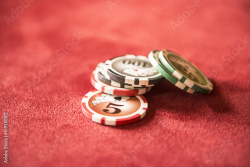 Poker tokens on red bacground