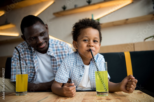 father and son drinking lemonade