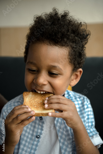 african american child eating toast