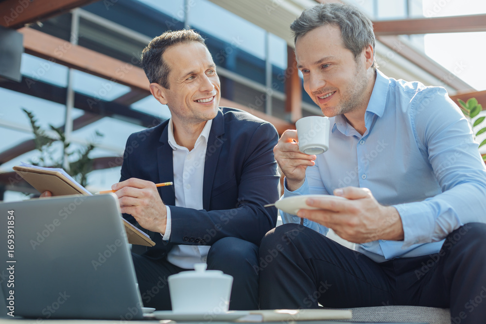 © Viacheslav Yakobchuk - Delighted positive businessman sitting with his business partner © Viacheslav Yakobchuk - Delighted positive businessman sitting with his business partner