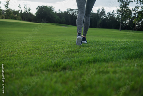 woman running on green lawn
