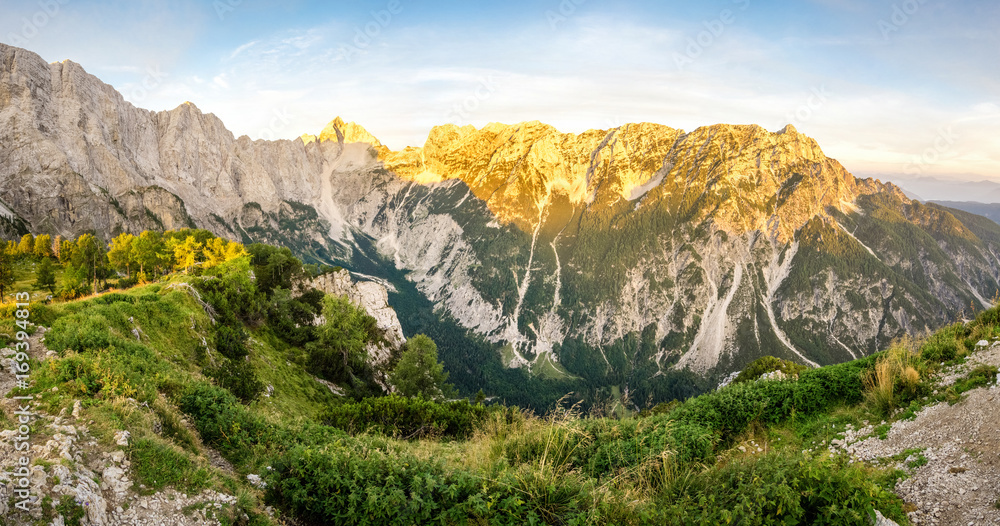 Great panoramic view to mountains and valley in sunset light with alpenglow.