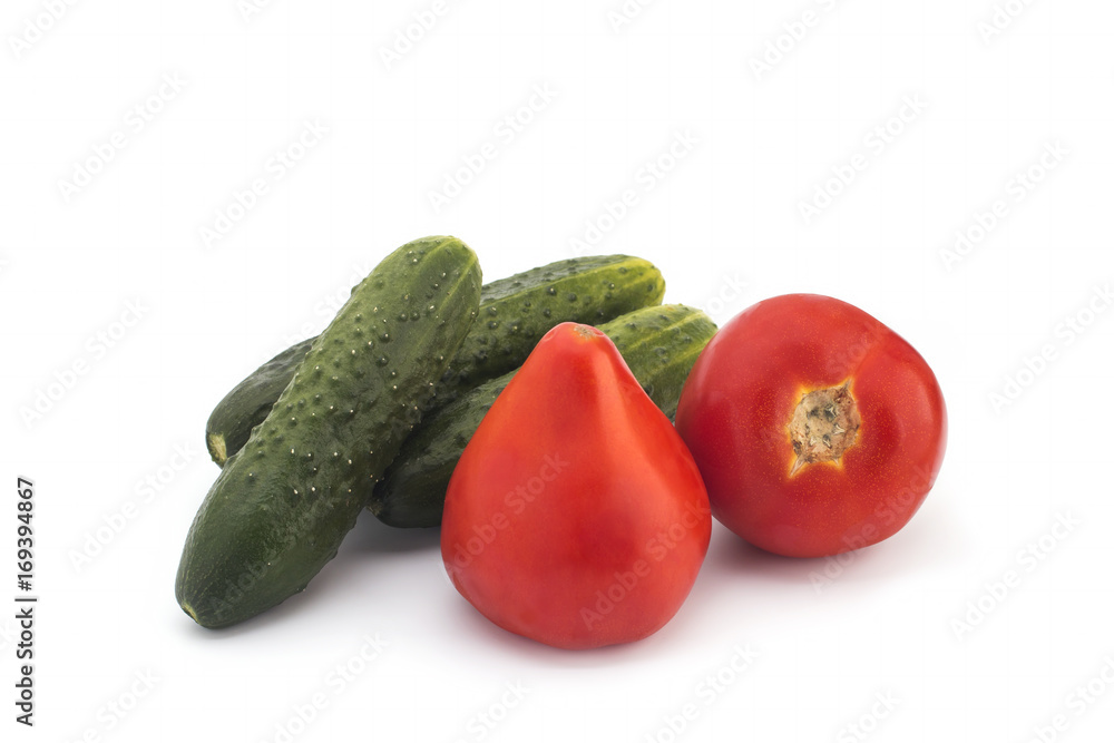 Red tomatoes and green cucumbers on a white background Red tomatoes and green cucumbers on a white background