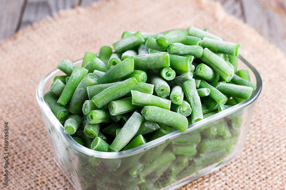 Frozen asparagus beans in a glass box Frozen asparagus beans in a glass box
