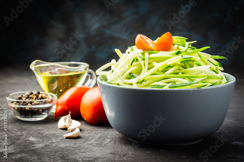 Raw ingredients for garlic, olive oil and tomato zucchini pasta. Selective focus, close up. photo