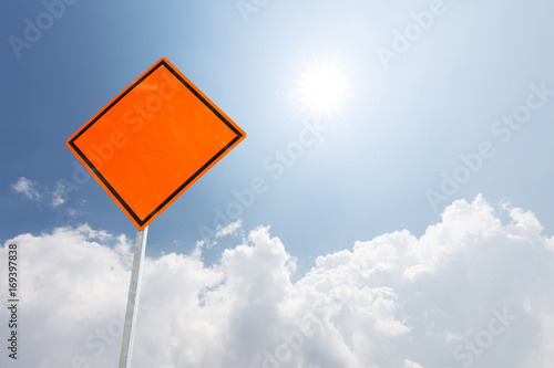 blank orange diamond sign in blue sky