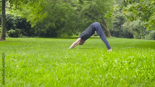 A man doing yoga exercises in the park photo