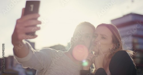 Cute couple making silly things and faces for selfie
