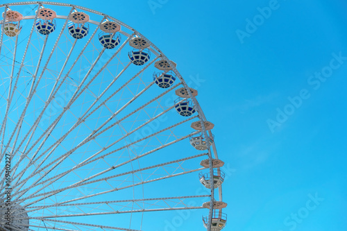 Ferris wheel on blue sky background. In the amusement Park. The weekend