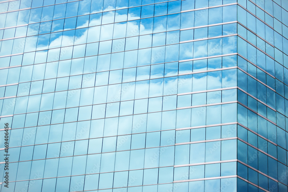 Blue sky and clouds reflecting in windows of modern office building Blue sky and clouds reflecting in windows of modern office building