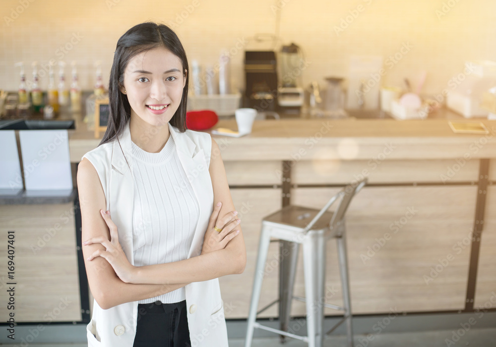 Happy Asian business woman in front of her coffee bar in cafe or coffee shop Happy Asian business woman in front of her coffee bar in cafe or coffee shop