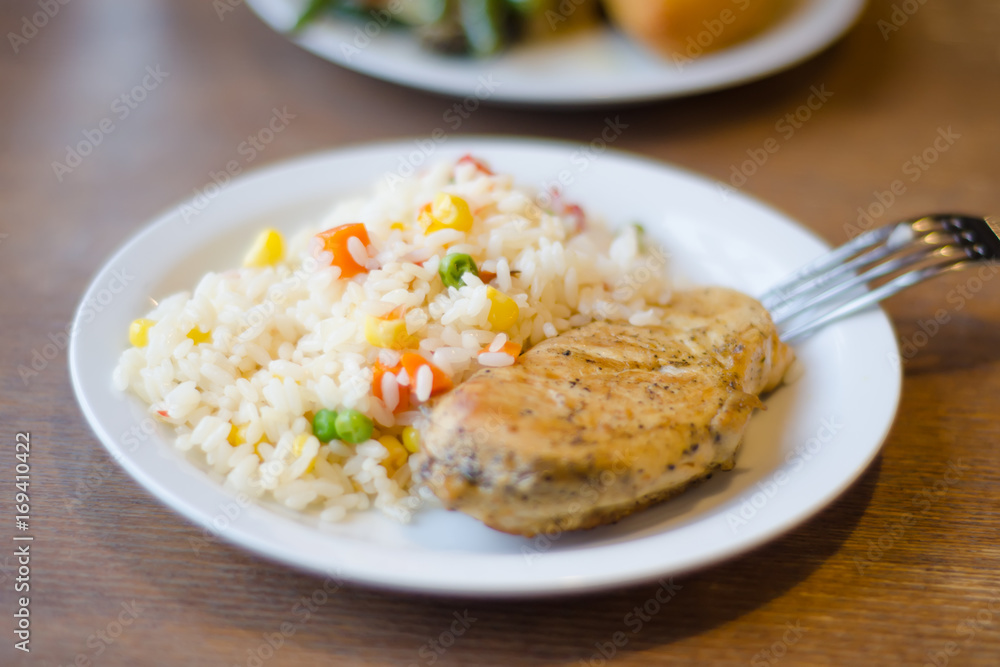 Rice with chicken steak on a plate