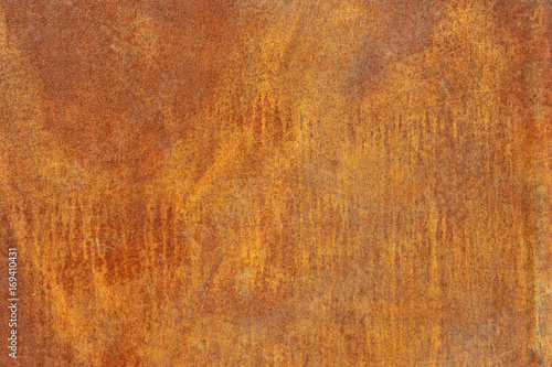 Orange brown old rusted corroded metal or steel sheet horizontal wall background as abstract dirty textured metallic vintage industrial closeup for retro grungy surface design. A rough iron aged plate