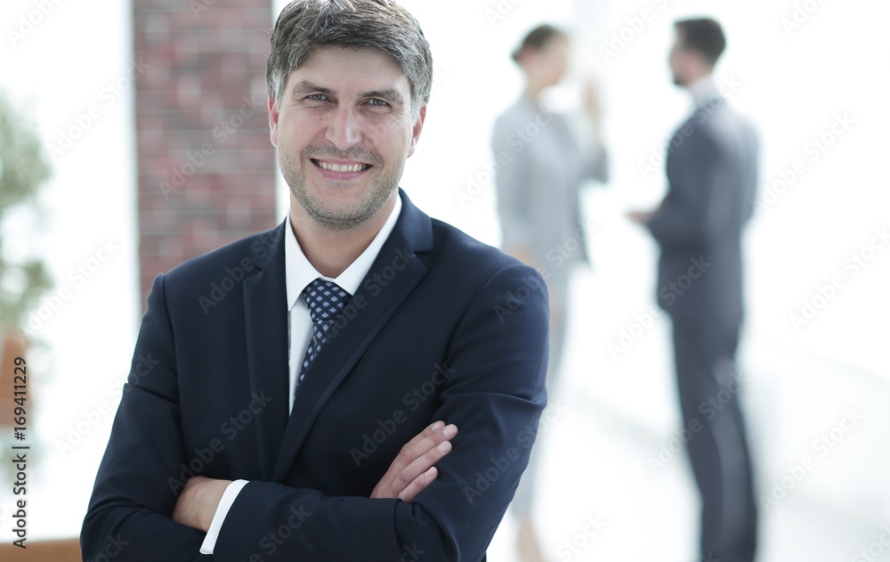 Fototapeta premium Portrait of confident businessman on office background