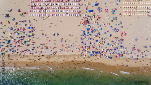 Aerial. Abstract photo of the sea, beach and vacationers from the sky.