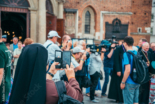 nun taking picture on her phone