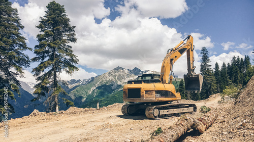 Digger working on a mountain road. Caucasus mountains, Svaneti region, Georgia