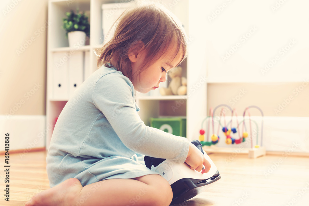 Toddler girl using a virtual reality headset in her house Toddler girl using a virtual reality headset in her house