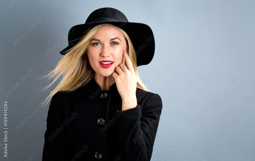 Beautiful young blonde woman in a black coat Beautiful young blonde woman in a black coat