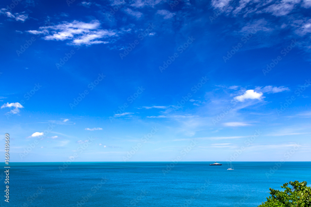 Sailing and floating boats floating in the sea on a clear blue sky.