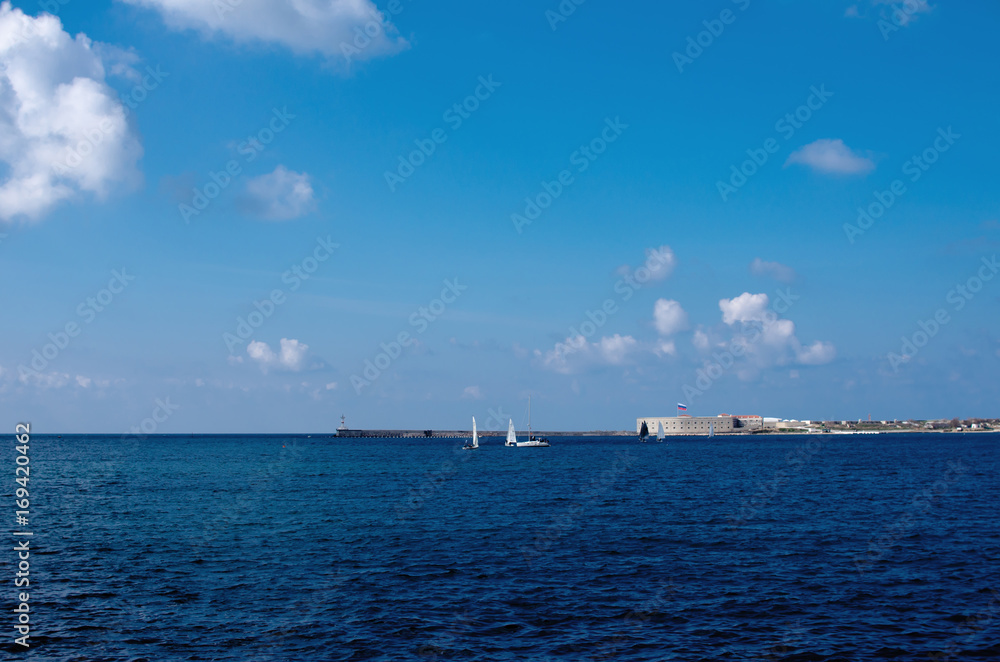 Entrance to the sea bay of Sevastopol with small yachts and ravelins in the background.