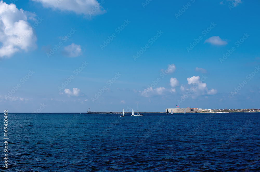 Entrance to the sea bay of Sevastopol with small yachts and ravelins in the background. Entrance to the sea bay of Sevastopol with small yachts and ravelins in the background.