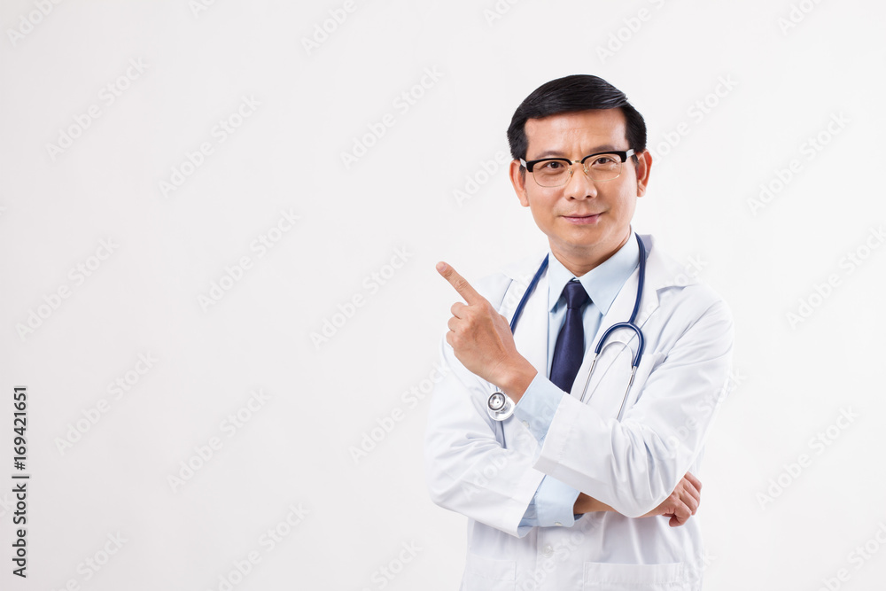 male doctor pointing finger up away to the left side male doctor pointing finger up away to the left side