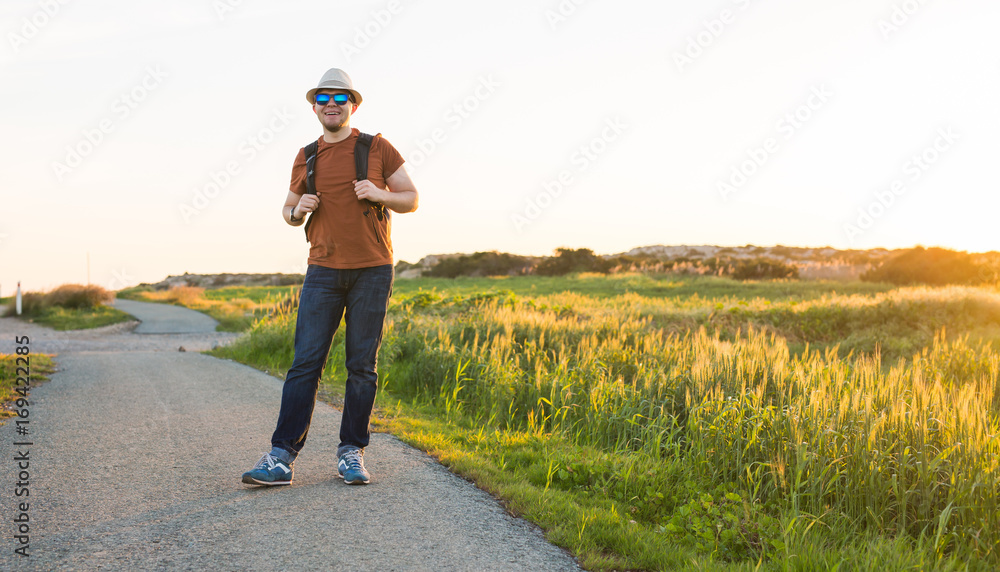 Young hipster man traveling backpacker outdoor. Travel concept. Young hipster man traveling backpacker outdoor. Travel concept.