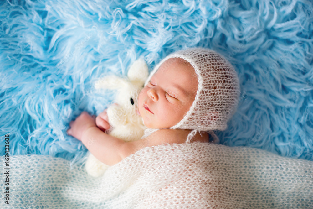 Little cute newborn baby boy, sleeping wrapped in white wrap Little cute newborn baby boy, sleeping wrapped in white wrap