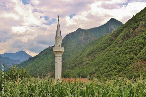 Minaret of a mosque in mountain landscape, between Shkoder and Theth national park. Albania, southeast Europe. photo