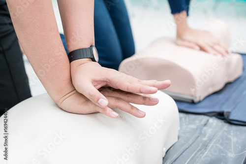 Nursing students are learning how to rescue the patient in emergency. CPR training with CPR doll. Closed-up. Soft focus.