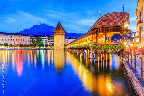 Lucerne, Switzerland. Historic city center with its famous Chapel Bridge and Mt. Pilatus in the background. 