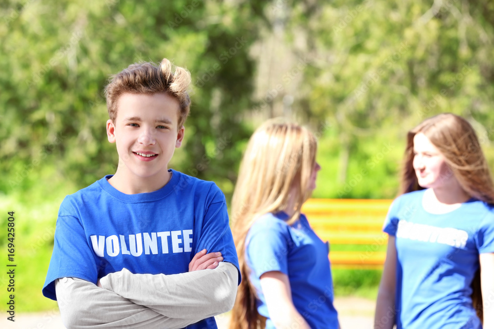 Young boy standing outdoors. Volunteering concept Young boy standing outdoors. Volunteering concept