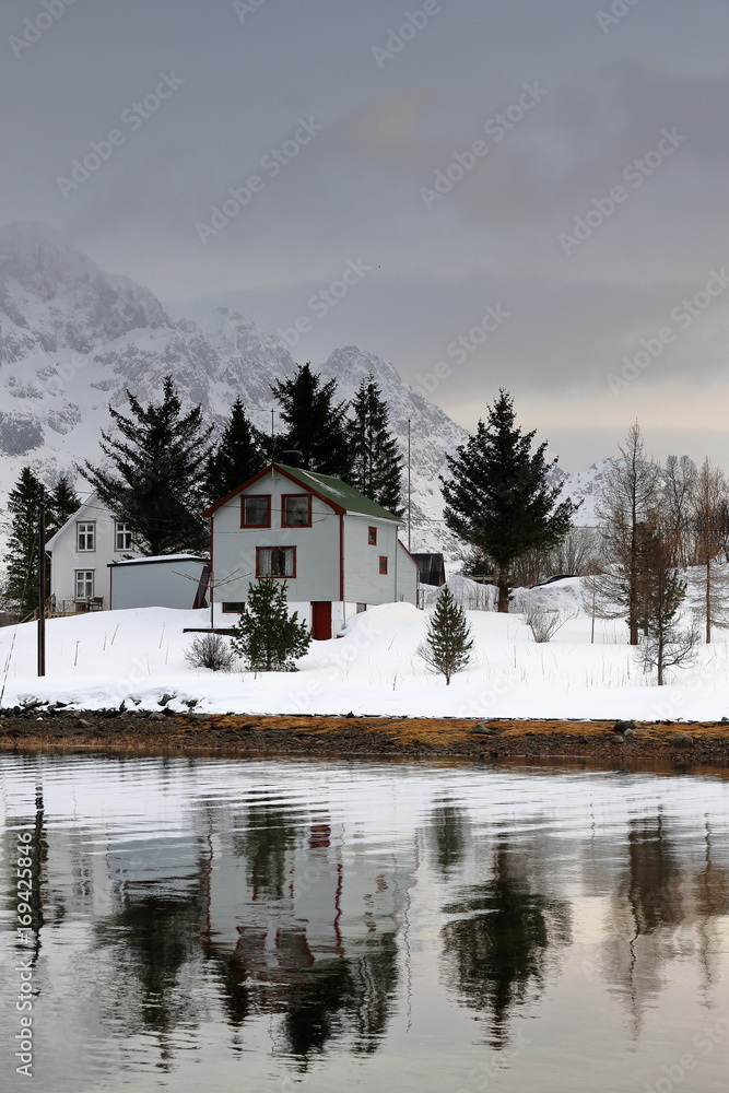 Cottages reflected in Austnesfjorden-Vestpollen village-central Austvagoya island. Nordland fylke-Norway. 0096