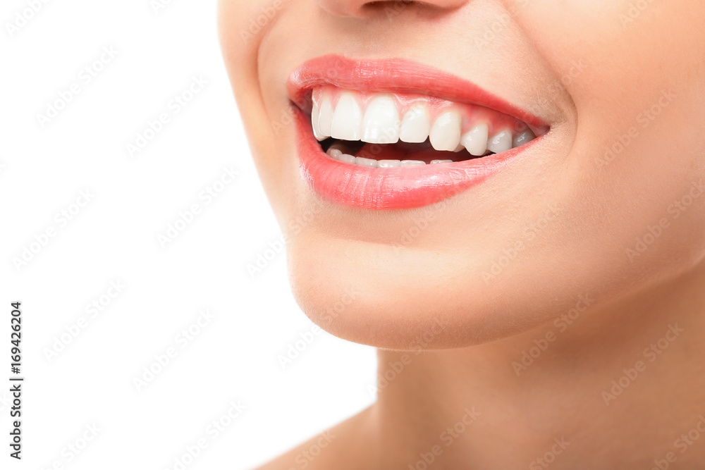 Naklejka premium Beautiful young woman with healthy teeth on white background