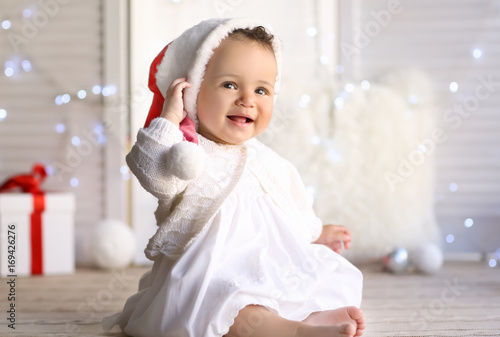 Cute little baby in Santa h...