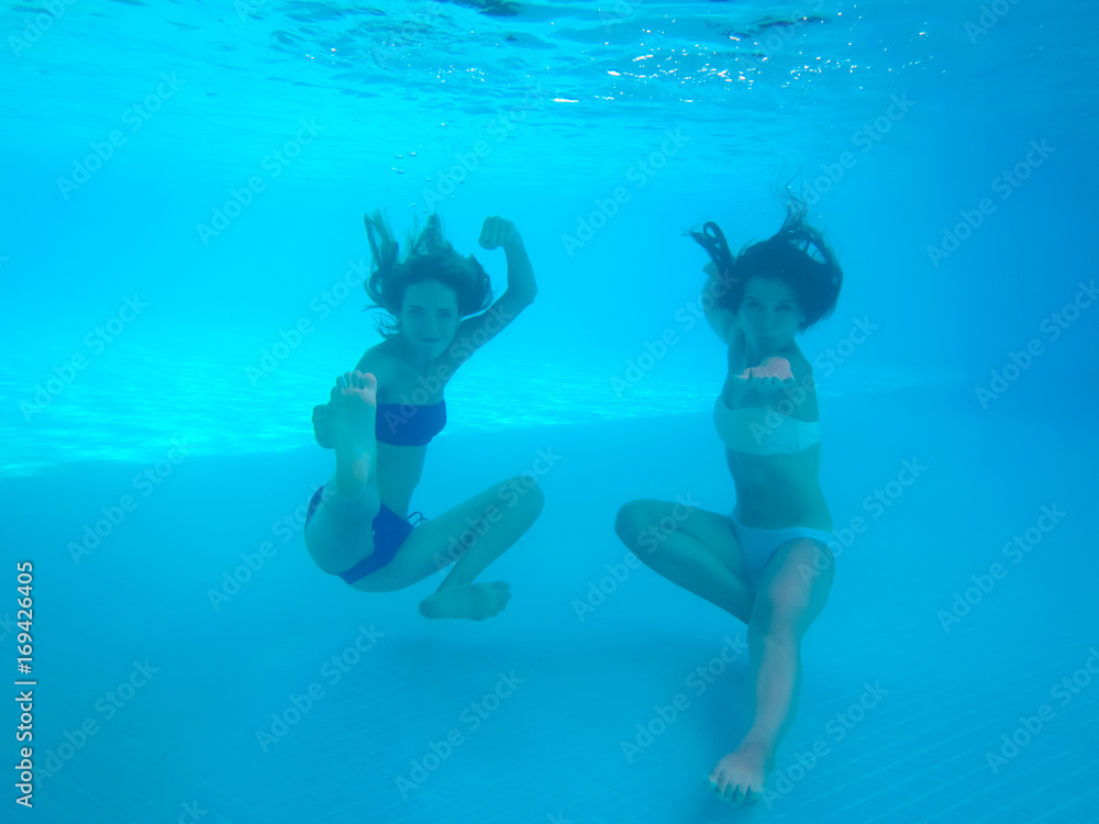 Beautiful young women having fun in swimming pool