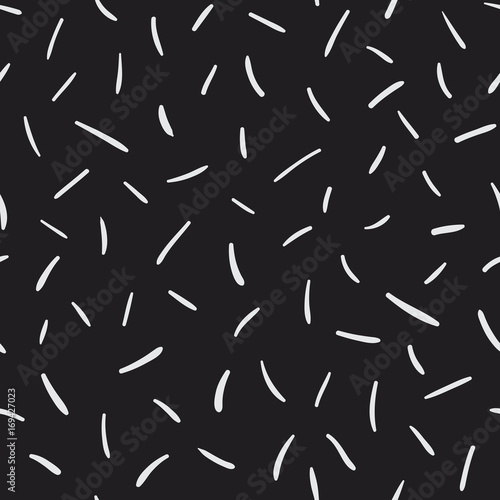 Memphis style scattered thin short lines. Random brush strokes, flying sticks and shapes. Funky decorative background for print, textile, wallpaper, home decor, packaging, wrapping, or web use.
