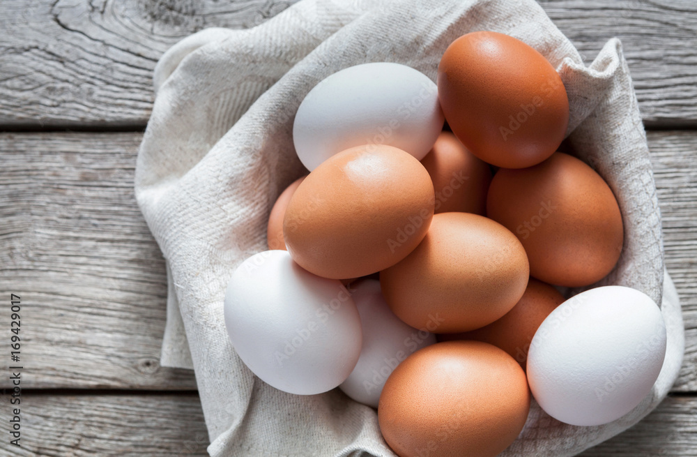 Fresh chicken brown eggs on rustic wood, organic farming concept Fresh chicken brown eggs on rustic wood, organic farming concept