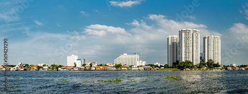 Cityscape with modern building near the river in the afternoon at Chao Phraya River in Bangkok, Thailand