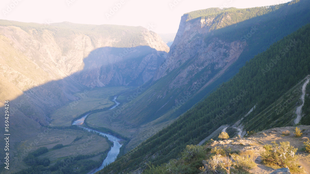 Mountain cliffs. Adventure hiking landscape revealing swirling road valley summer nature beauty background Mountain cliffs. Adventure hiking landscape revealing swirling road valley summer nature beauty background