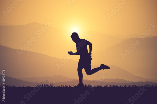 Wallpaper Mural silhouette of jogger in sunset.Vintage color Torontodigital.ca