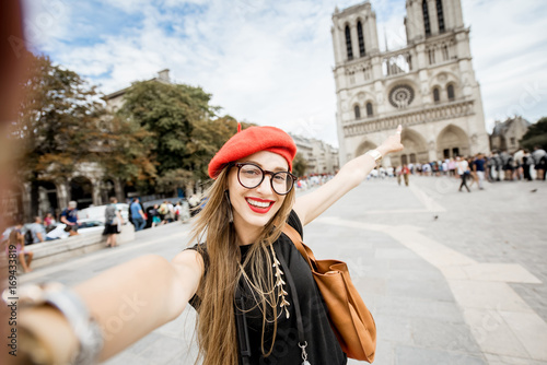 Photography Young woman tourist in red cap making selfie photo standing in front of the famo