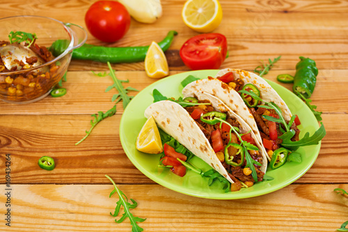 Mexican tacos with beef in tomato sauce